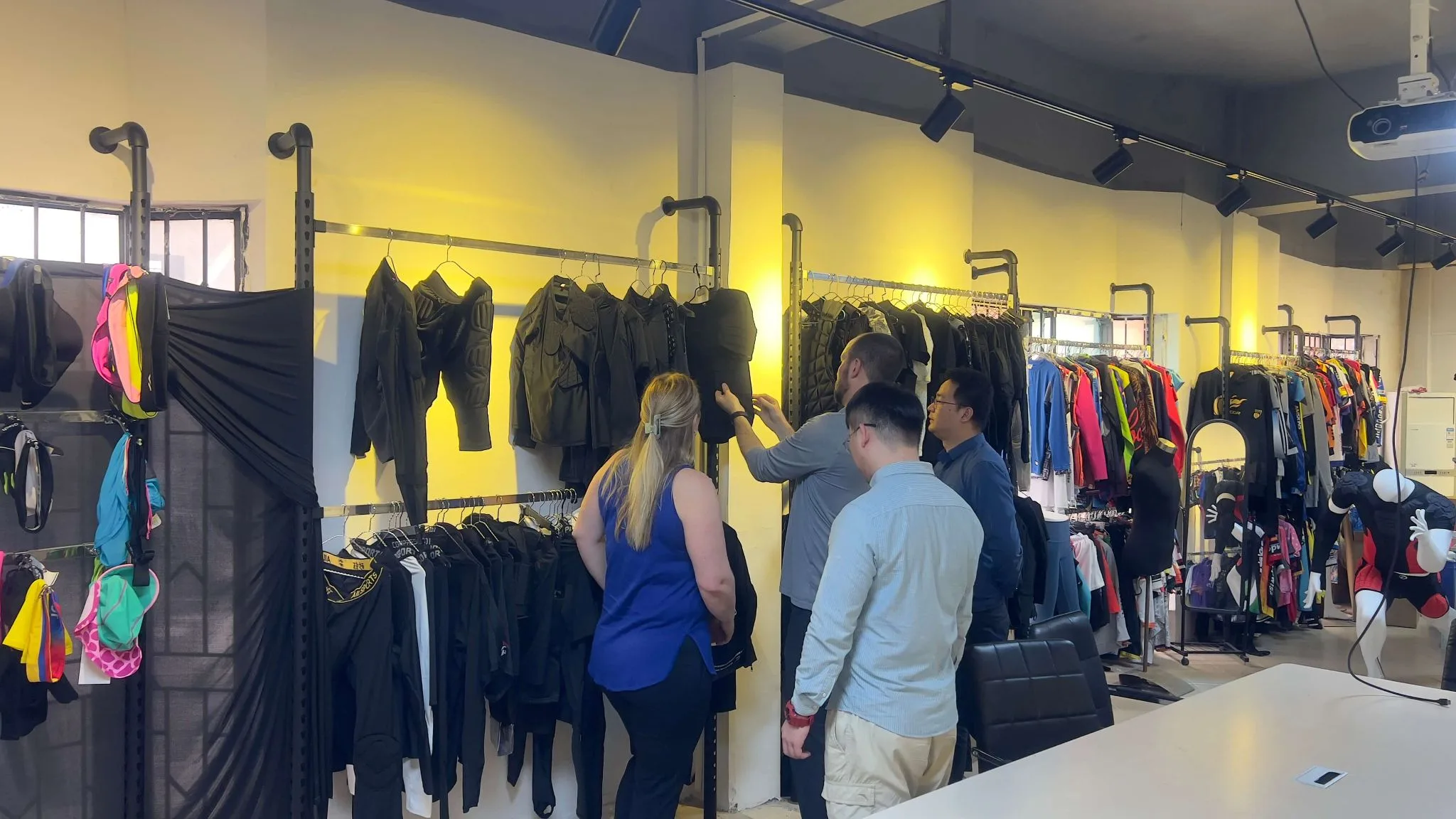 SHENOCHI team reviewing protective sportswear with visiting customers in the Dongguan factory showroom