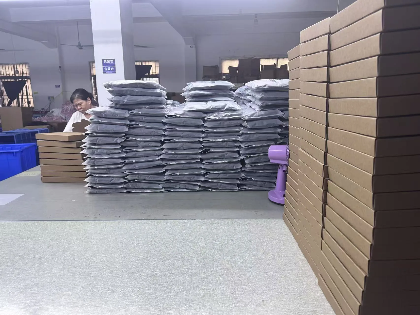 Individually bagged garments and cartons prepared in the SHENOCHI packing area