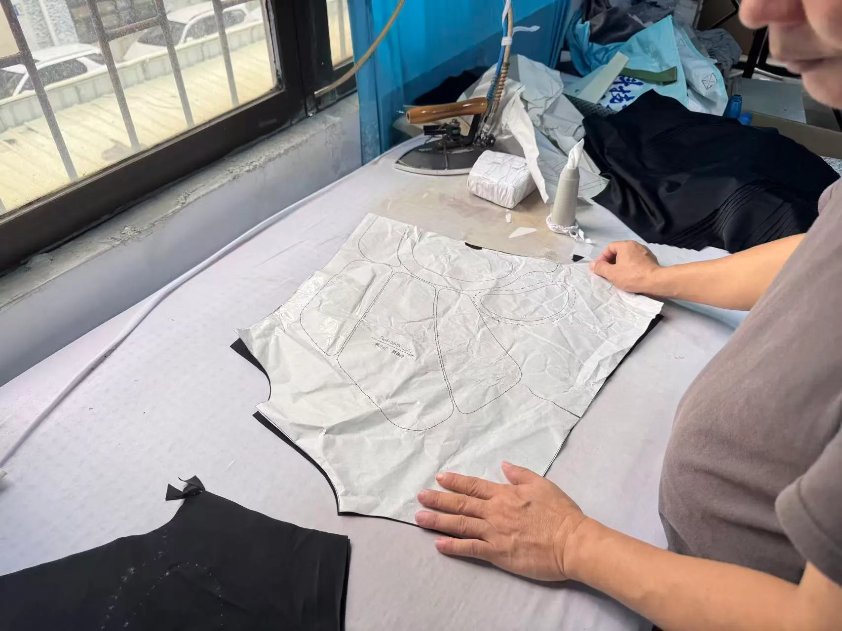 Factory team reviewing a product pattern for sports protective gear